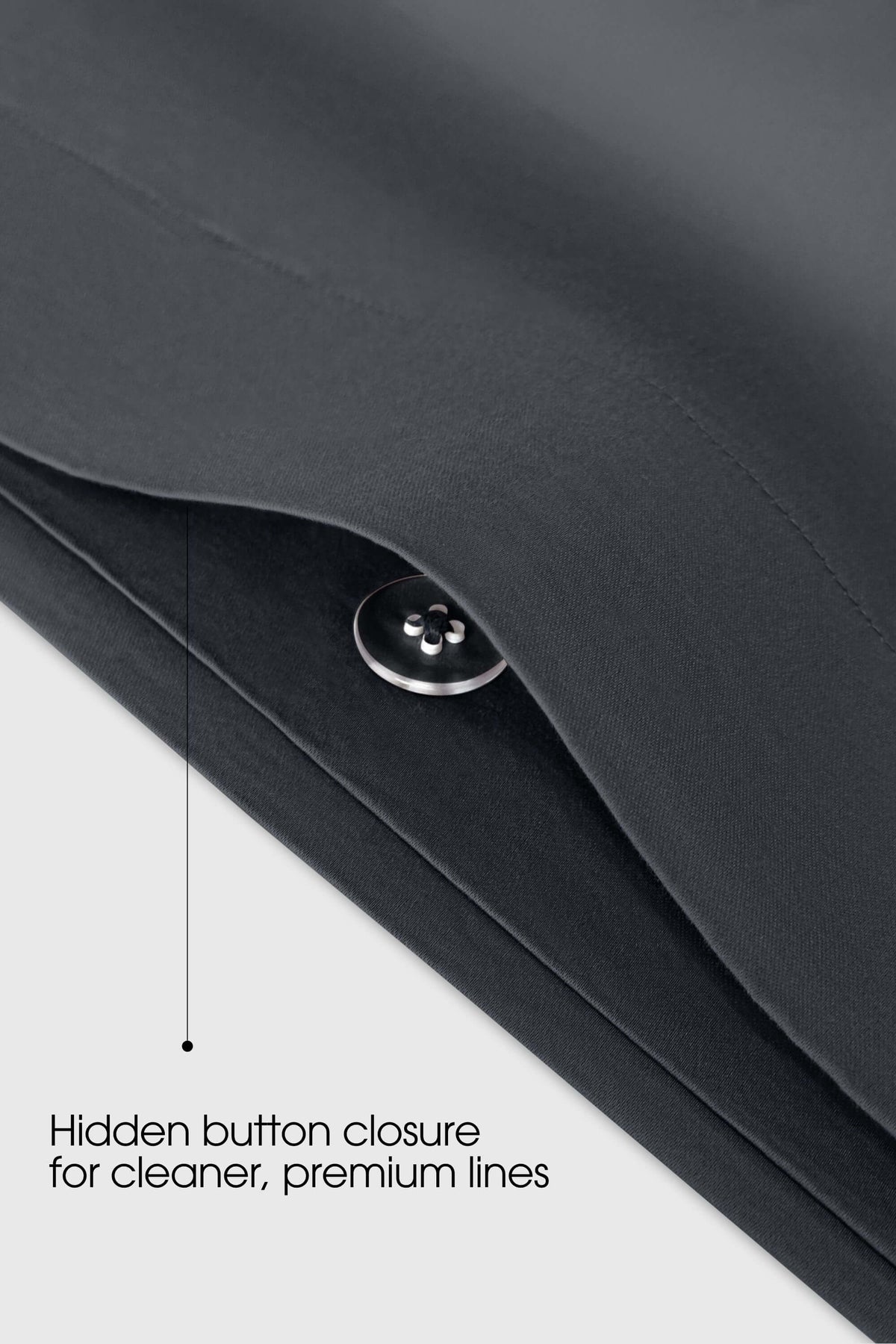 Concealed button fastening on a dark grey sateen duvet cover, close up
