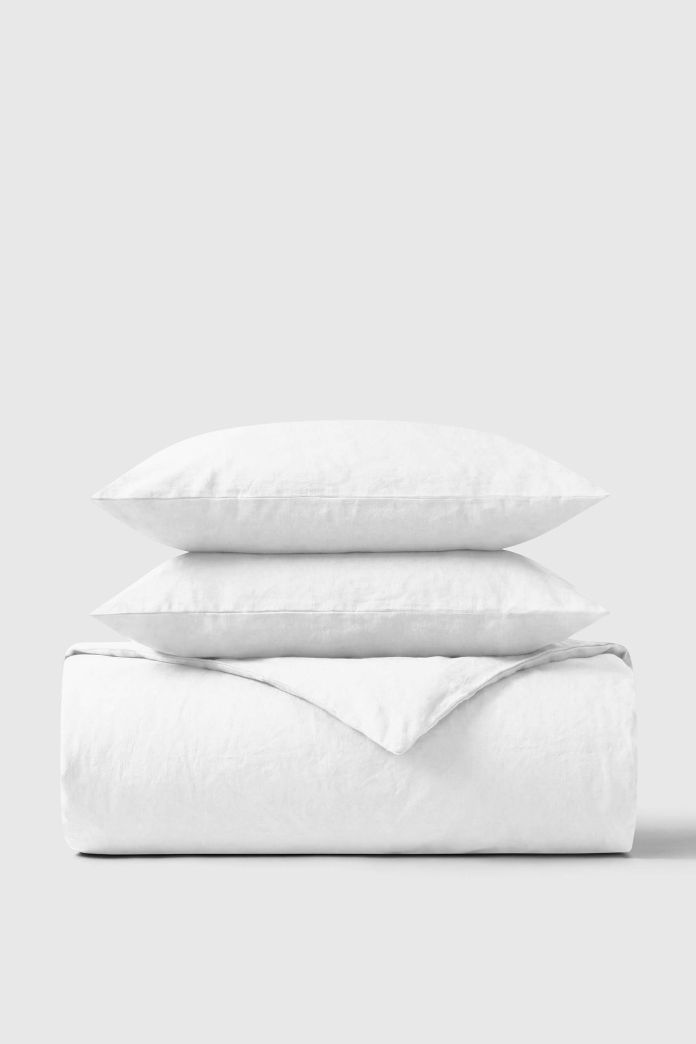 A bed made up in white Bedable percale, showing the duvet cover
