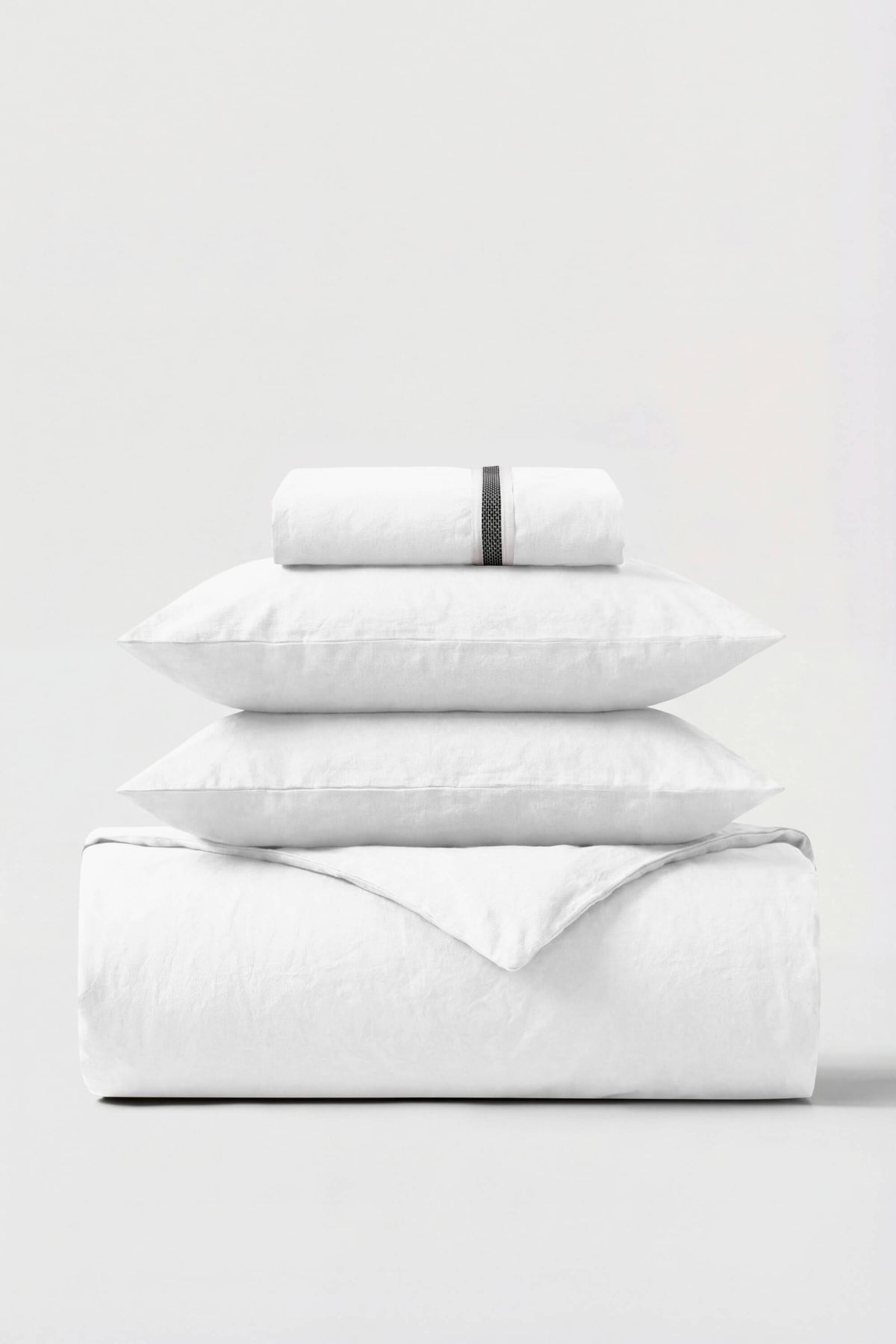 Goose feather and down pillows air drying flat on a rack
